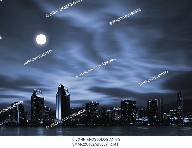 Night skyline of futuristic city with full moon