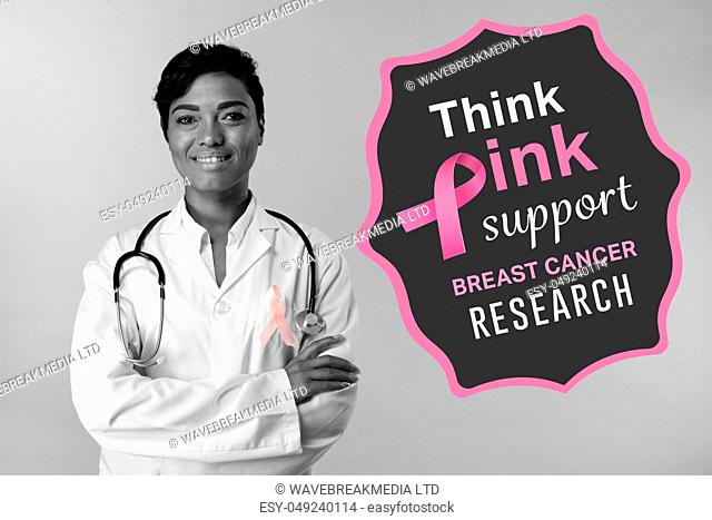 Breast cancer awareness message against smiling nurse wearing breast cancer awareness ribbon