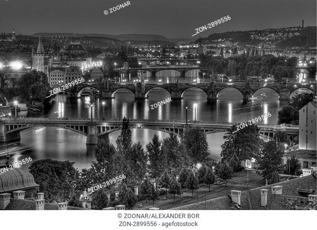 The Charles Bridge in the middle of the image, the second one is a pretty famous historical bridge that crosses the Vltava river in Prague, Czech Republic