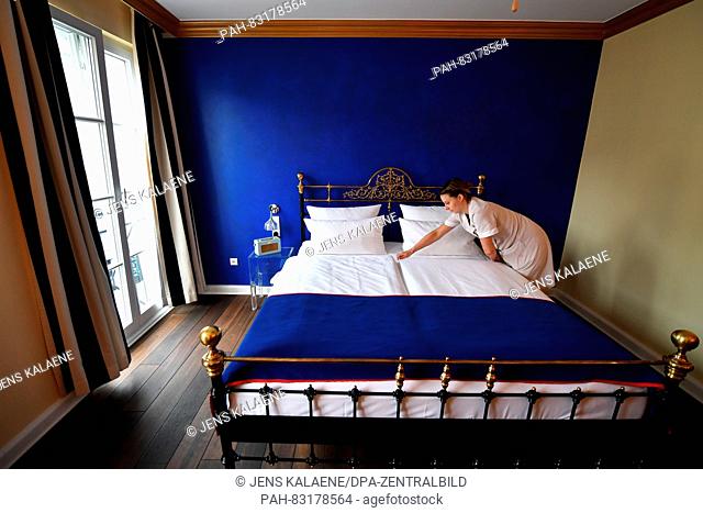 A service employee makes a bed in the private, owner-managed Berlin boutique- and design-hotel THE DUDE on Kopenicker Strasse 92 in Berlin, Germany