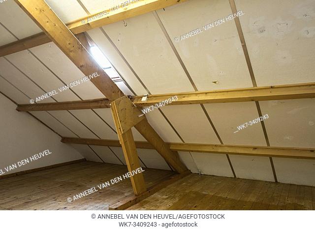 Attic, roof before construction with window and wooden beams old