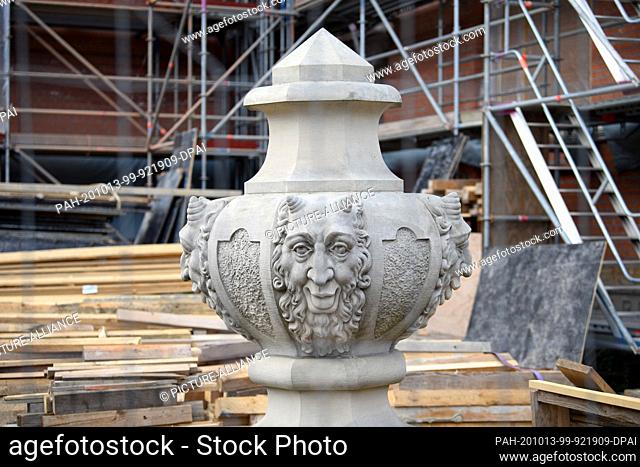 06 October 2020, Brandenburg, Potsdam: A flame vase with a satyr head is placed on the floor before being transported to the balustrade above the eastern...