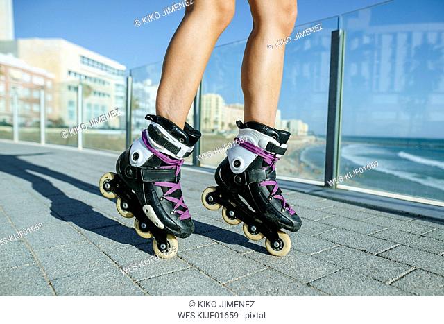 Close-up of woman's legs with inline skates