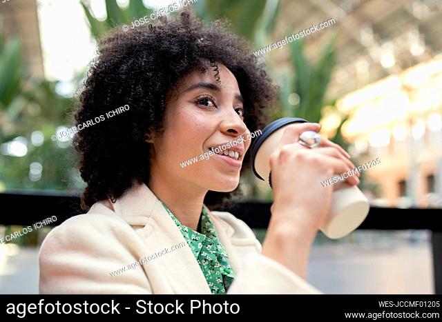Thoughtful young woman having coffee at cafe