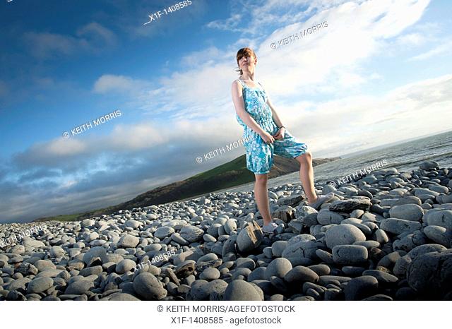 A 16 year old girl wearing an outfit she designed for her GCSE textiles exam course work, Wales UK