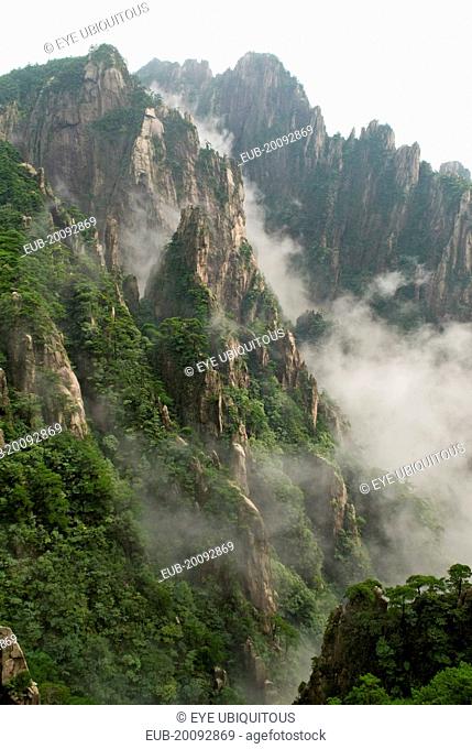 Huangshan or the Yellow Mountain. Rock peaks with lush green pine trees and a sea of cloud. Has inspired countlless painters and poets over the ages and has a...