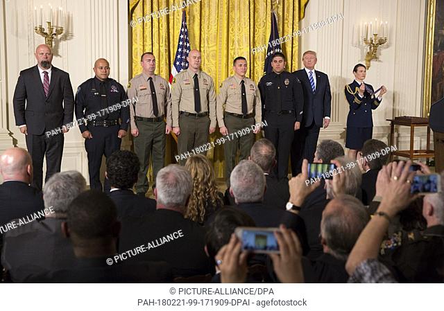 United States President Donald J. Trump stands with District Attorney Investigator Chad Johnson, San Bernardino County District Attorney's Office(left)