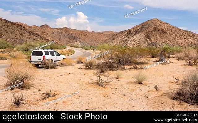 Driving with a car through the desert in California USA