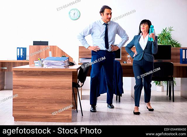 The two employees doing sport exercises in the office