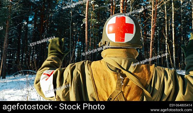 Dressed As American Soldier Medic Of USA Infantry Of World War II Come Out Of Ambush With Hands Up And Surrender To Captivity