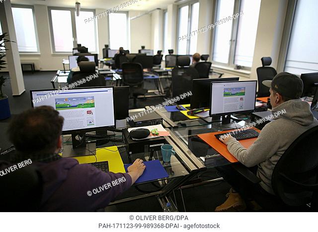 Employees working at their computers from the Competence Call Center, under management by Facebook, in Essen, Germany, 23 November 2017