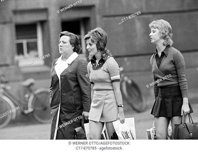 Seventies, black and white photo, people, two young girls, pullover, miniskirt, aged 16 to 20 years, older woman, coat, aged 50 to 60 years, everyday life