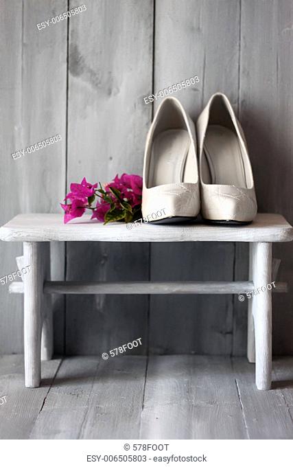 Photo of white shoes and flowers