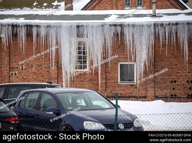 15 February 2021, Lower Saxony, Goslar: Icicles hang from the roof of an industrial plant and reach almost to the ground. Photo: Lino Mirgeler/dpa