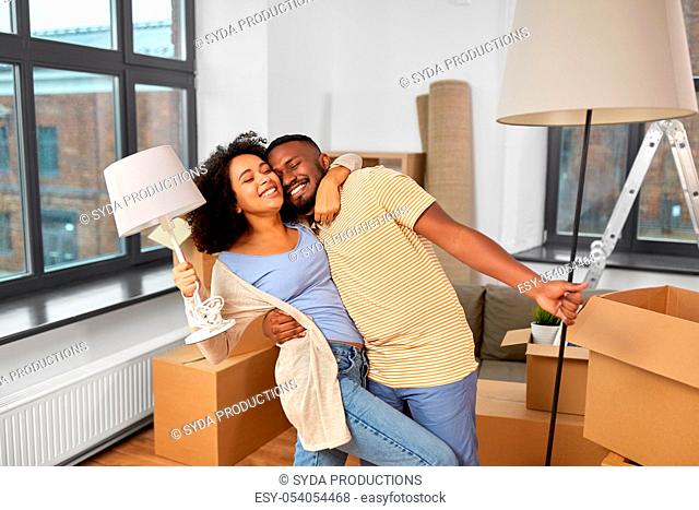 happy couple packing boxes and moving to new home