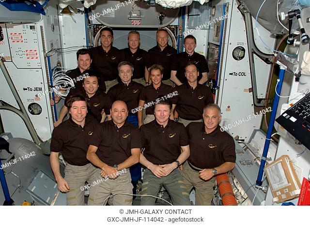 The STS-127 and Expedition 20 crew members pose for a group portrait in the Harmony node of the International Space Station while the Space Shuttle Endeavour...