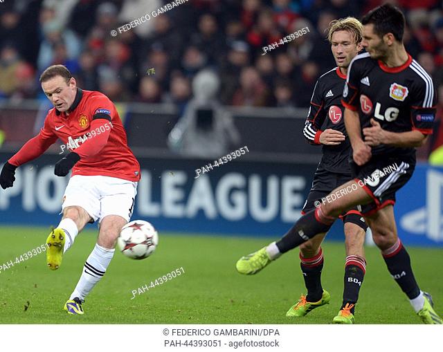 Leverkusen's Simon Rolfes (2ND-R) and Emir Spahic and Manchester's Wayne Rooney (L) vie for the ball during the Champions League soccer match between Bayer 04...