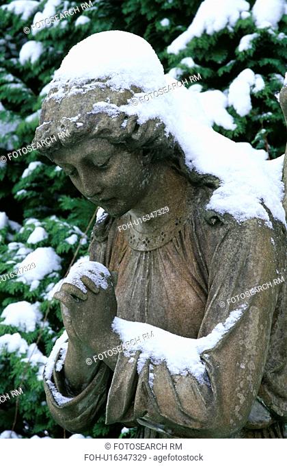 Sculpture in snow in country garden in winter