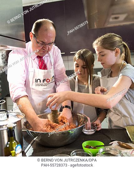 Christian Schmidt (L, CSU), Minister of Food and Agriculture cooks with pupils of the Schule Eins school in Berlin, Germany, 09 February 2015
