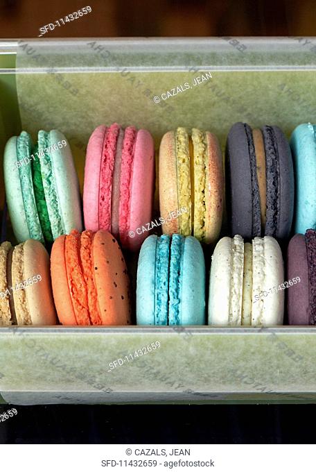 Various different coloured macaroons in a box