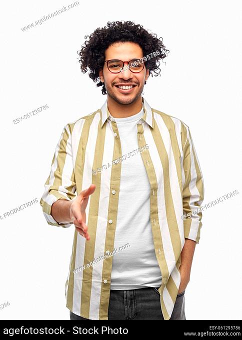 happy man in glasses giving hand for handshake