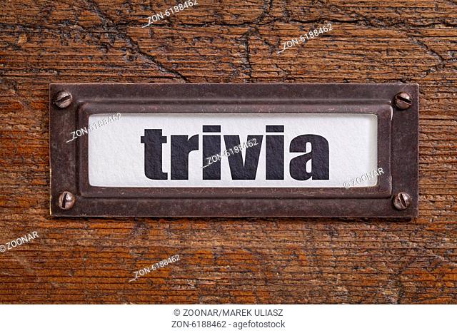 trivia - file cabinet label, bronze holder against grunge and scratched wood