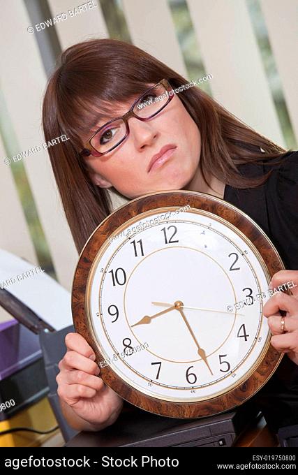 unhappy woman holding big watch