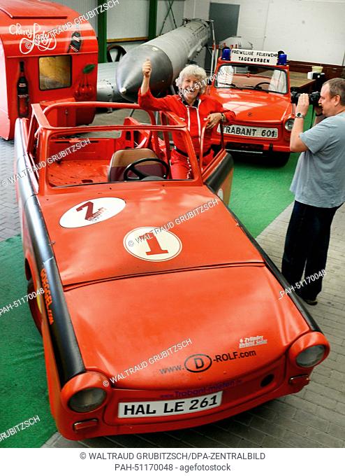 Rolf Becker (C) brings a Trabant car, which runs on manure, to the Aviation and Technology Museum in Merseburg, Germany, 16 August 2014