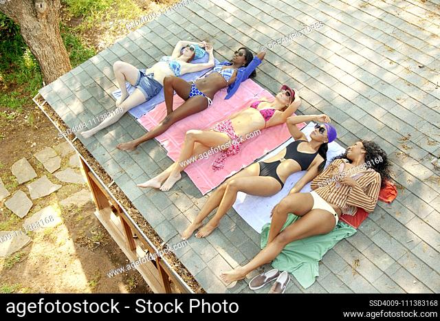 Friends sunbathing on roof