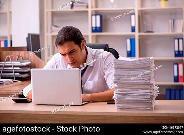 Young employee unhappy with excessive work in the office