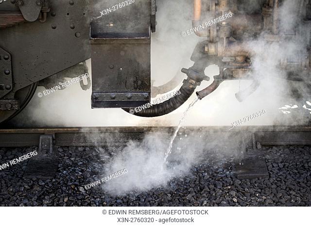 Steam coming up from underneath a train at Goathland railway station in England