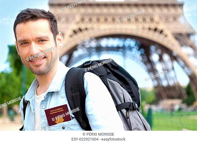 Young attractive traveler in Paris with passport