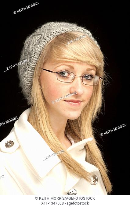 A slim blonde short-sighted 14 year old teenage girl wearing glasses , UK