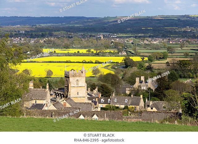 St. Lawrence church and oilseed rape fields, Bourton-on-the-Hill, Cotswolds, Gloucestershire, England, United Kingdom, Europe