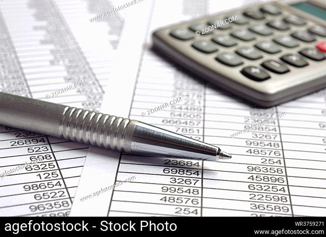 financial accounting with table sheet and calculator
