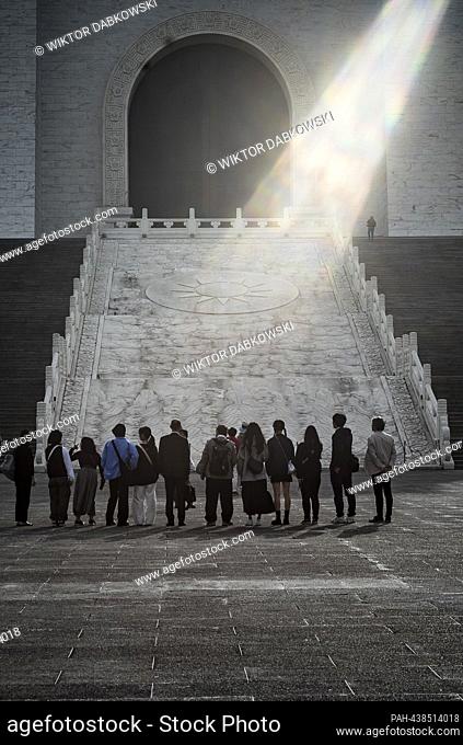 A group of people waits at the base of the grand stairway leading to the Chiang Kai-shek Memorial Hall in Taipei, Taiwan on 13/12/2023 by Wiktor Dabkowski