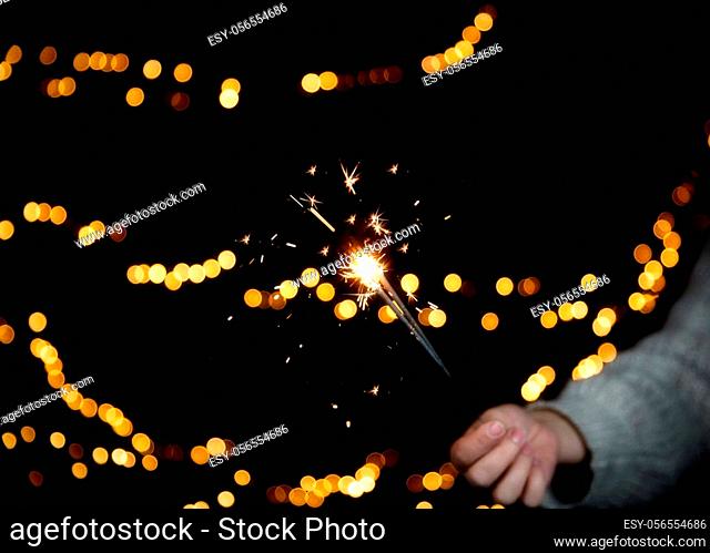 Burning Sparkler with Festive bokeh background for New Year and Christmas concept, space for text colorful design