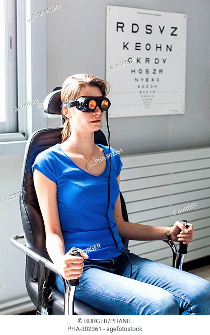 Vestibular rehabilitation with physiotherapist, here rotatory test in rotary chair with glasses Frenzell, Limoges hospital, France