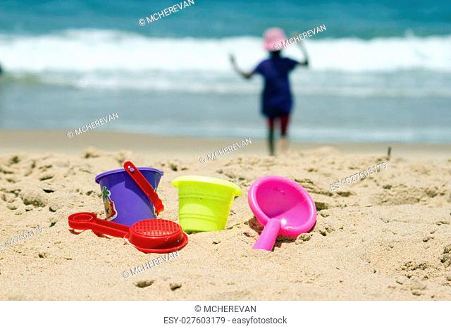 Children's colorful sandy toys on beautiful a beach. India Goa