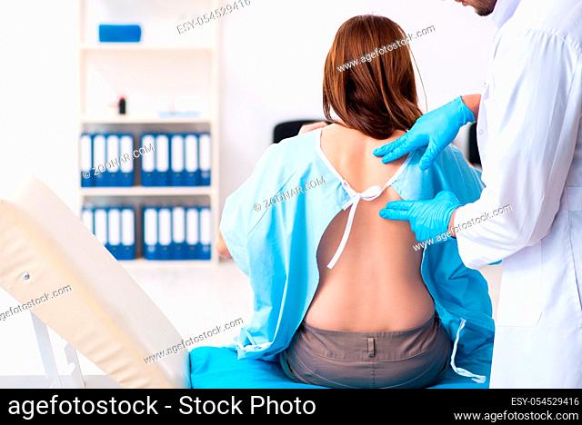 Injured young woman visiting male doctor