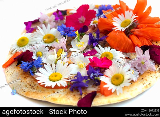 Creative pizza covered with colorful flowers