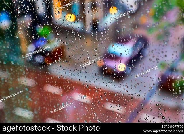 Raindrops on a window with urban street in the background