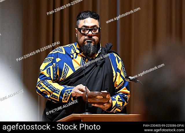 05 April 2023, Baden-Württemberg, Stuttgart: Mana Caceres from Hawaii holds a bowl of water during a ceremonial return of human remains from indigenous...