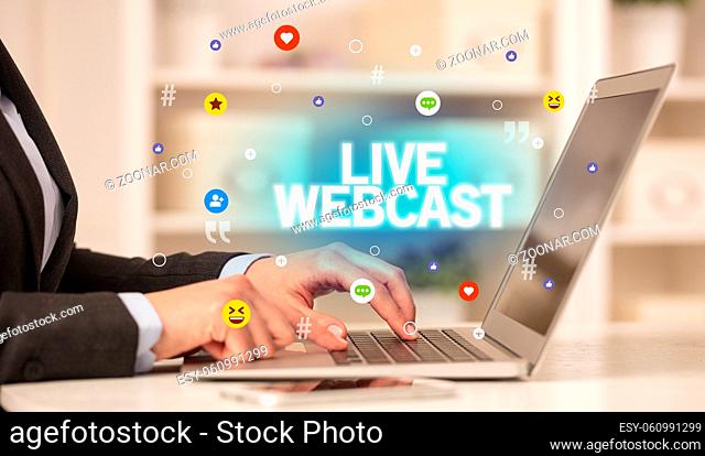 Freelance woman using laptop with LIVE WEBCAST inscription, Social media concept