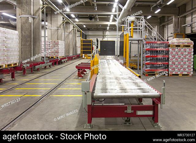 Warehouse, and distribution centre for goods, pallets, lifting equipment, and racking. Shrinkwrapped cartons and boxes of beer for transport