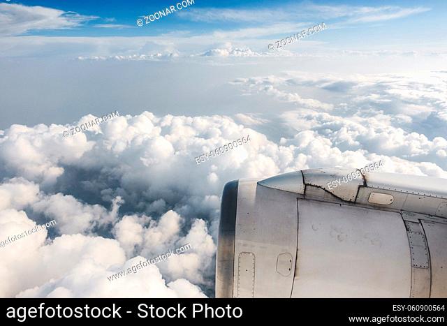 Slightly dirty airliner jet engine and cloudy sky, airplane in flight