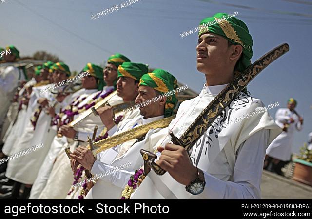 09 December 2020, Yemen, Sanaa: Yemeni grooms dressed in traditional attires attend a traditional mass wedding, held by the Houthis for thousands of couples
