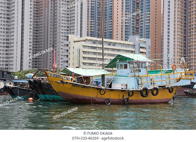Fishing boats at Shaukeiwan with condominiums in background, Hong Kong