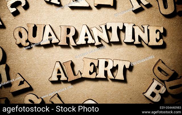 Quarantine Alert sentence on a brown paper
