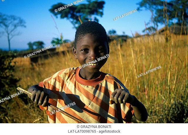 Field of tall grass. Young person smiling